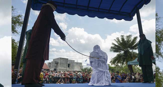 A woman is publicly flogged in front of a mosque in the provincial capital Banda Aceh on April 20, 2018. PHOTO: CHAIDEER MAHYUDDIN / AFP
