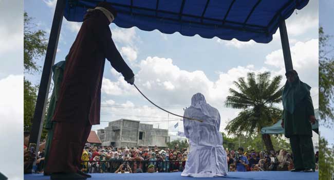 A woman is publicly flogged in front of a mosque in the provincial capital Banda Aceh on April 20, 2018. PHOTO: CHAIDEER MAHYUDDIN / AFP