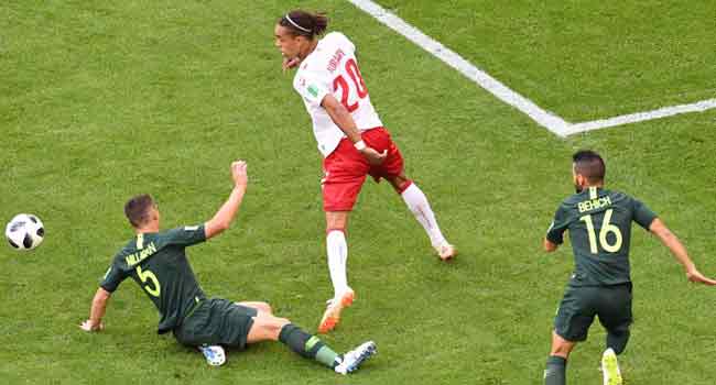 Denmark's forward Yussuf Poulsen (C) vies for the ball with Australia's defender Mark Milligan (L) and Australia's defender Aziz Behich (R) during the Russia 2018 World Cup Group C football match between Denmark and Australia at the Samara Arena in Samara on June 21, 2018. EMMANUEL DUNAND / AFP