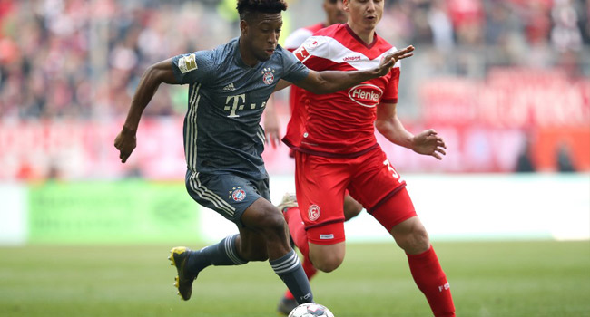 Bayern Munich's French defender Kingsley Coman (L) and Duesseldorf's German midfielder Marcel Sobottka (R) vie for the ball during the German first division Bundesliga football match in Duesseldorf, western Germany on April 14, 2019. Ronny Hartmann / AFP