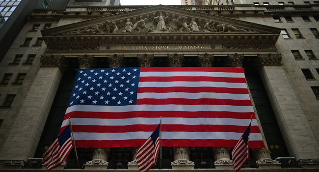 US flags are pictured outside the New York Stock Exchange (NYSE) on September 12, 2019 at Wall Street in New York City. Johannes EISELE / AFP