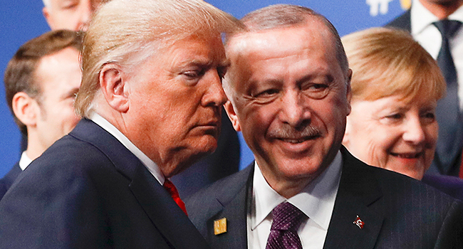 US President Donald Trump (L) and Turkey's President Recep Tayyip Erdogan (R) leave the stage after the family photo to head to the plenary session at the NATO summit at the Grove hotel in Watford, northeast of London on December 4, 2019. PETER NICHOLLS / POOL / AFP