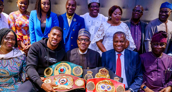 PHOTOS: Anthony Joshua Presents Heavyweight Titles To Buhari In UK