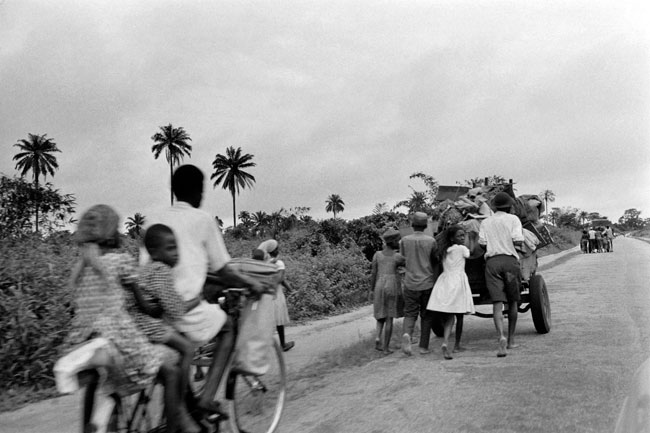 In this file photograph taken on August 28, 1968, civilians flee Aba to go to Umuahia, the new capital of the Republic of Biafra, as the Nigerian federal troops advance toward the city during the Biafran war. Francois Mazure / AFP