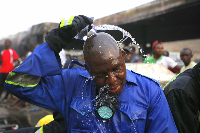 A fire fighter cool off his head after battling fire that gutted a petrol station along Kubwa Expressway in Abuja on Wednesday 26th February, 2020. Photo: Sodiq Adelakun/Channels TV