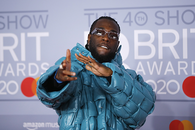 Nigerian singer-songwriter Burna Boy poses on the red carpet on arrival for the BRIT Awards 2020 in London on February 18, 2020. (Photo by Tolga AKMEN / AFP)