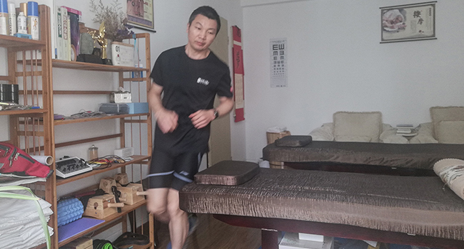 This handout picture taken and released courtesy of Pan Shancu on February 14, 2020 shows Pan Shancu running in his bedroom in Hangzhou, China's eastern Zhejiang province. Handout / Pan Shancu / AFP