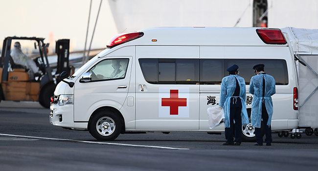 An ambulance carrying passengers drives away from the Diamond Princess cruise ship, with around 3,600 people quarantined onboard due to fears of the new coronavirus, at the Daikoku Pier Cruise Terminal in Yokohama port on February 10, 2020. CHARLY TRIBALLEAU / AFP