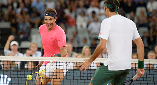 Spain's Rafael Nadal (L) plays a return to Switzerland's Roger Federer (R) during their tennis match at The Match in Africa at the Cape Town Stadium, in Cape Town on February 7, 2020. RODGER BOSCH / AFP