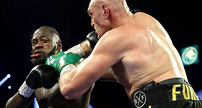 Tyson Fury (R) punches Deontay Wilder during their Heavyweight bout for Wilder's WBC and Fury's lineal heavyweight title on February 22, 2020 at MGM Grand Garden Arena in Las Vegas, Nevada. Al Bello/Getty Images/AFP