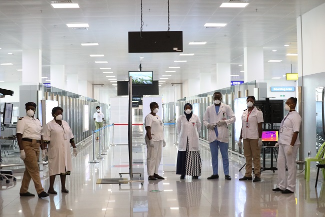 Health workers supervising the scan to check the spread of Corona Virus in Nigeria on standy at the entrance of Nnamdi Azkiwe International Airport, Abuja. PHOTO: Sodiq Adelakun