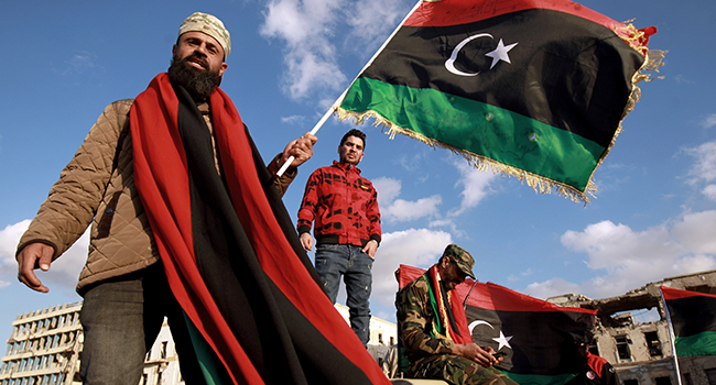 Libyans wave their national flag as they take part in a celebration marking the Libyan revolution, which toppled strongman Moamer Kadhafi, in Benghazi on February 17, 2020. Abdullah DOMA / AFP