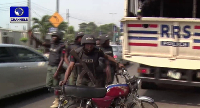 A Lagos state police officer impounds a motorcycle on Saturday, February 1, 2020.