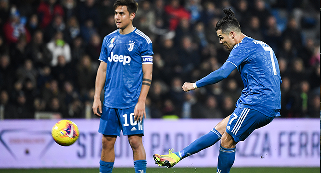 Juventus' Portuguese forward Cristiano Ronaldo shoots a free-kick next to Juventus' Argentine forward Paulo Dybala during the Italian Serie A football match SPAL vs Juventus on February 22, 2020 at the Paolo-Mazza stadium in Ferrara. Isabella BONOTTO / AFP