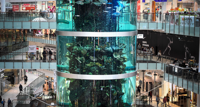 Visitors walk around a huge aquarium in Aviapark shopping mall in Moscow on February 18, 2020.