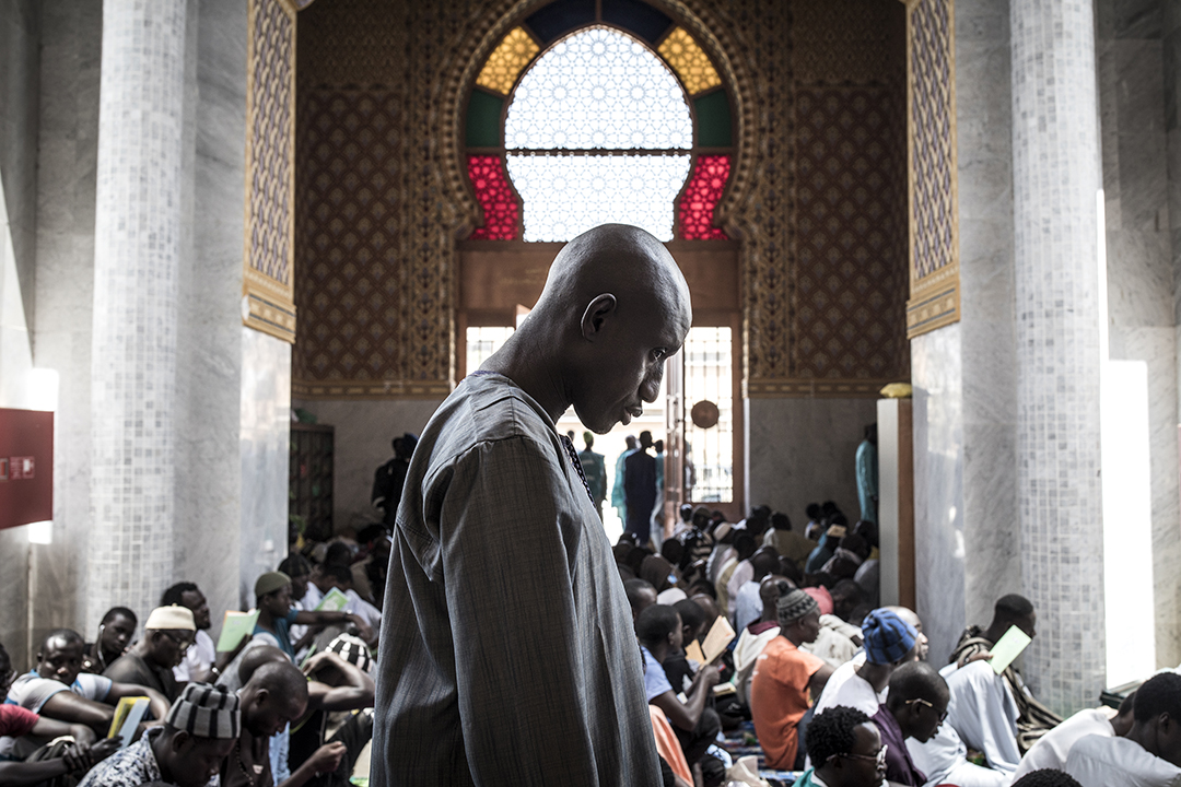 A Muslim worshipper attends a mass prayer against COVID-19, the new coronavirus, in Dakar on March 4, 2020, after two cases were confirmed in Senegal in the previous days. Photo by John Wessels / AFP