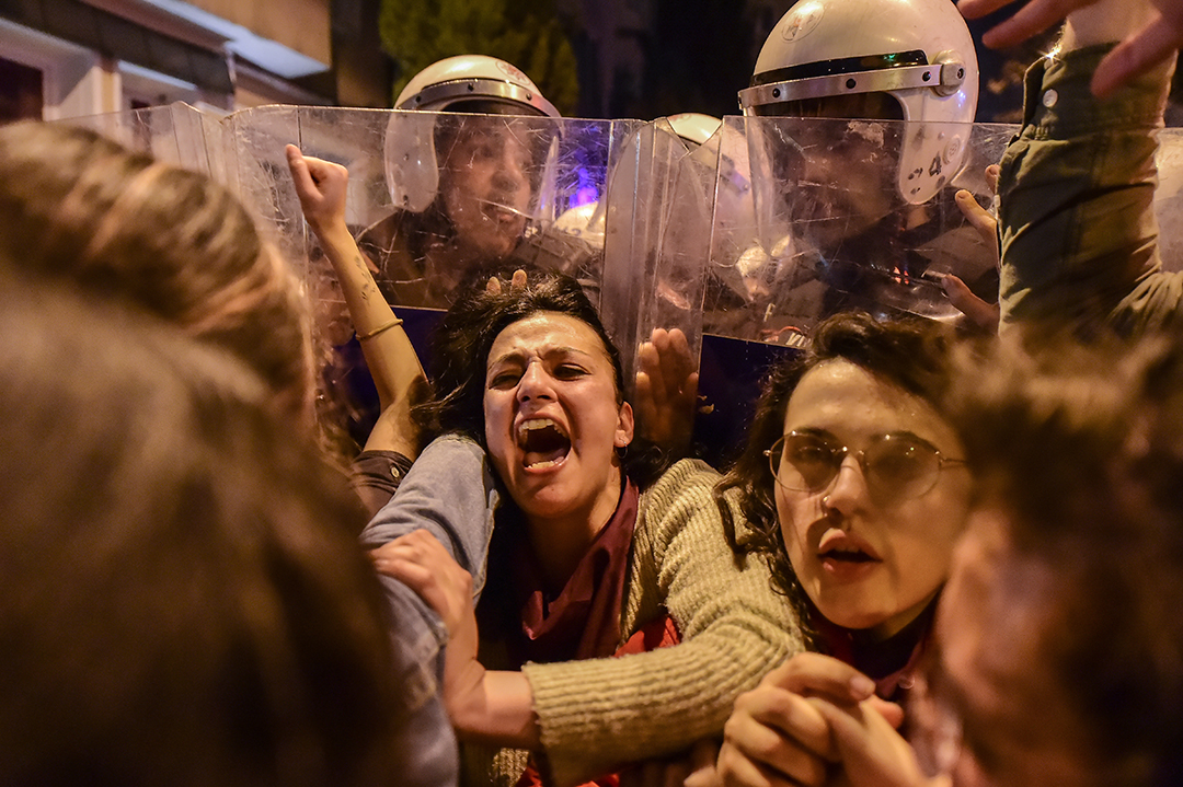 Turkish anti-riot police officers push back women during a rally marking International Women's Day on Istiklal avenue in Istanbul on March 8, 2020. - Istanbul police fired tear gas at thousands of women who took to the city's central avenue on International Women's Day on March 8 in defiance of a protest ban to demand greater rights and denounce violence. Photo Yasin AKGUL / AFP