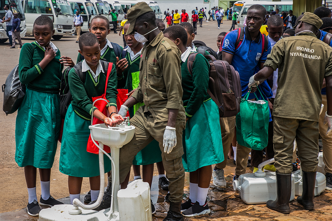 Secondary school students wash their hands at temporary hand washing point before they return home as Rwandan Government decided to send back all students of boarding schools after the first case of COVID-19, caused by the novel coronavirus was found on March 13, in Kigali, on March 16, 2020. Photo: AFP