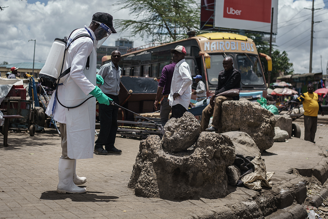 A staff member of Kenya's Ministry of Health sprays disinfectant on a rock which people sit on to curb the spread of the COVID-19 coronavirus at the Gikomba Market in Nairobi, Kenya, on March 21, 2020. - African countries have been among the last to be hit by the global COVID-19 coronavirus epidemic but as cases rise, many nations are now taking strict measures to block the deadly illness. Photo: AFP