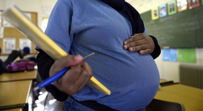 A pregnant student poses on July 29, 2013 in Pretoria at the Pretoria Hospital School specialised in teenage pregnancy. The Pretoria Hospital School, a Public School opened in 1950 and originally dedicated to sick children, is the only school of its kind in South Africa. AFP PHOTO / STEPHANE DE SAKUTIN