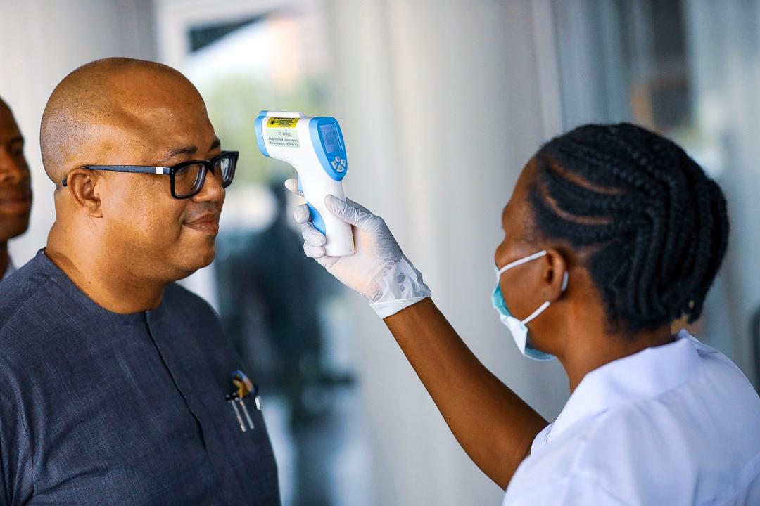 Dr. Chikwe Ihekweazu, the Director General of the Nigeria Centre for Disease Control (NCDC) has his temperature checked during a diplomatic meeting at the Ministry of Foreign Affairs in Abuja, Nigeria March 12, 2020. Photo: Sodiq Adelakun / Channels TV