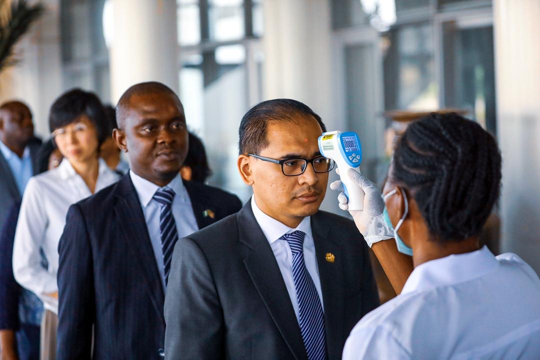 Diplomats have their temperatures checked at the Ministry of Foreign Affairs complex in Abuja during a diplomatic meeting at the Ministry of Foreign Affairs in Abuja, Nigeria March 12, 2020. Photo: Sodiq Adelakun / Channels TV