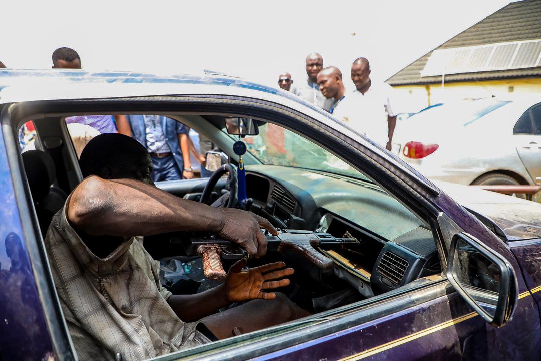 An armed robber displays how he hide guns in a car during a parade by the Special Anti-Robbery Squad of the Nigerian Police Force in Abuja on March 11th, 2020. Photo: Sodiq Adelakun / Channels TV