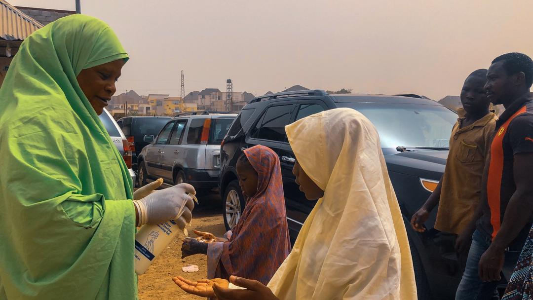 Muslim faithfuls receive drops of hand sanitiser during Juma’ah prayers in Abuja, On March 13th, 2020. Photo: Sodiq Adelakun / Channels TV