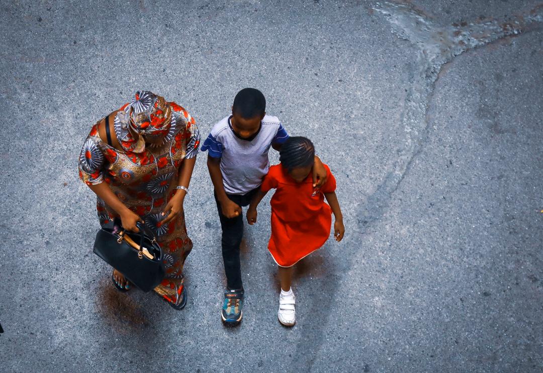 A woman takes her children to work after schools were asked to closed down in Abuja. The closure is part of precautionary measures adopted to curtail further spread of the virus on Friday, March 20th 2020. Photo: Sodiq Adelakun / Channels TV