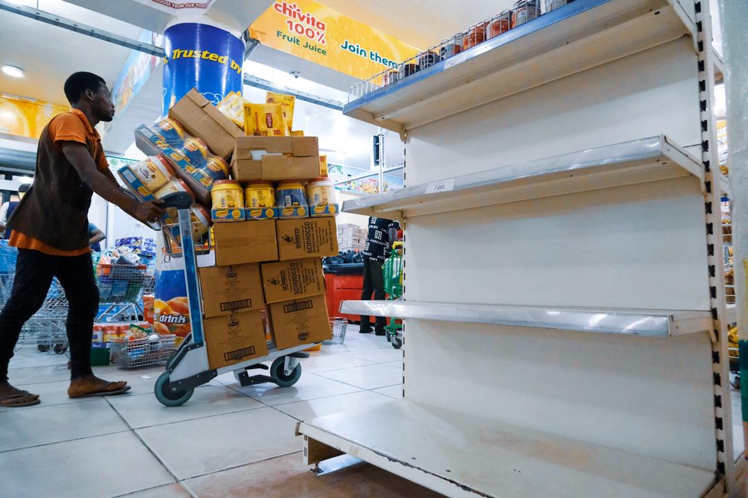 A man pushes a cart at a store in Abuja on Friday, March 20th, 2020. Photo: Sodiq Adelakun / Channels TV