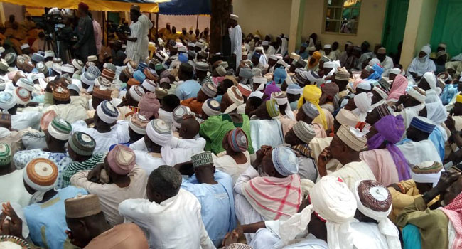 A crowd gathers at the Emir of Daura palace on Saturday, March 21 to pray against the deadly coronavirus.