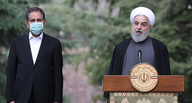 A handout picture provided by the Iranian presidency on March 18, 2020 shows President Hassan Rouhani (R) chairing a cabinet meeting alongside Vice President Eshagh Jahangiri in the capital Tehran. Iranian Presidency / AFP