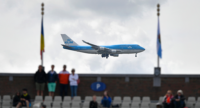 In this file photo A Boeing 747 commercial plane of KLM airline lands at Shipol airport behind spectators watching the European Athletics Championships at the Olympic stadium in Amsterdam on July 6, 2016. FABRICE COFFRINI / AFP