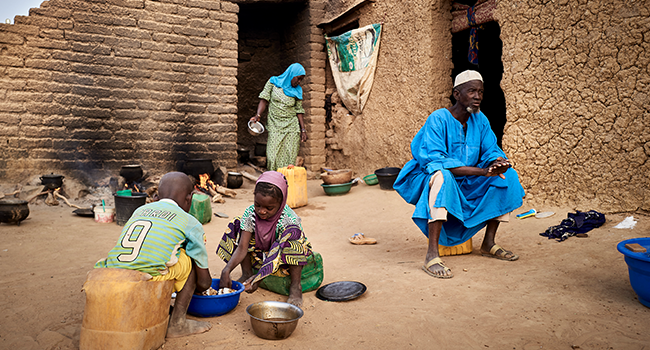 A displaced family is seen in a courtyard of Sevare where they found a shelter after fleeing their village of Guerri in central Mali, on February 27, 2020. In January 2019 Jihadists broke in the village, setting fire on it, killing 3 villagers, and stealing all the livestock. MICHELE CATTANI / AFP