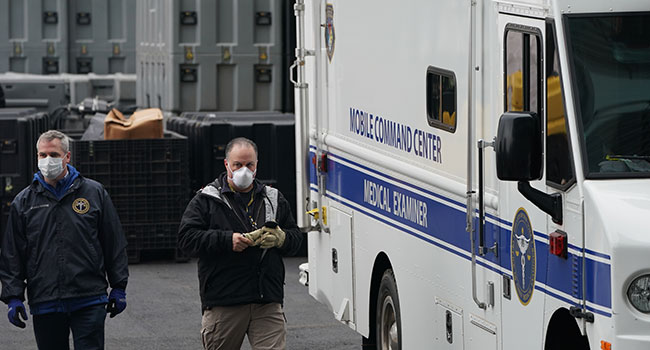 Members of the NYC Medical Examiner’s Office at the site as workers build a makeshift morgue outside of Bellevue Hospital to handle an expected surge in Coronavirus victims on March 25, 2020 in New York. Bryan R. Smith / AFP