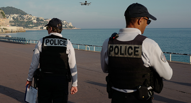 Police officers use a drone to control people on the 'Promenade des Anglais' in the French Riviera city of Nice, on March 19, 2020, on the third day of a strict lockdown in France to stop the spread of COVID-19, caused by the novel coronavirus. VALERY HACHE / AFP