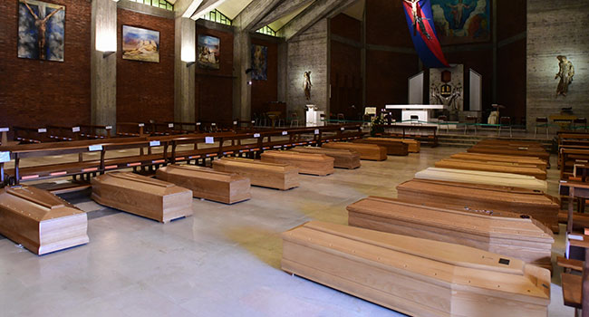 A general view shows coffins of the deceased stored in the church of San Giuseppe in Seriate, near Bergamo, Lombardy, on March 26, 2020, during the country's lockdown following the COVID-19 new coronavirus pandemic. Piero CRUCIATTI / AFP