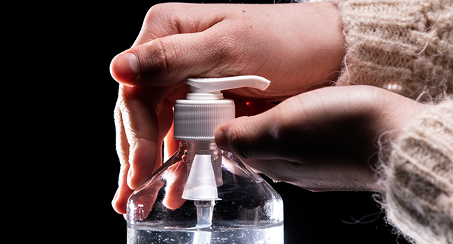 In this file photo taken on March 05, 2020 a person takes from a bottle of hydroalcoholic hand sanitizer in Paris amid a spread of COVID-19, the novel coronavius. Lionel BONAVENTURE / AFP