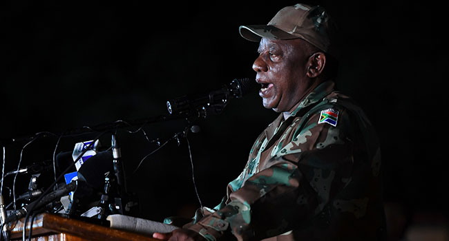 South African President Cyril Ramaphosa dressed in military fatigues talks to soldiers of the South African National Defence Force (SANDF) at the Doornkop Military Base in Soweto, on March 26, 2020, as they get ready to maintain public order during the national lockdown scheduled from March 26, 2020 until April 16, 2020 to prevent the spreading of the COVID-19 coronavirus outbreak in South Africa. AFP