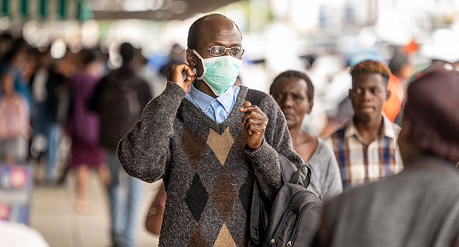 A man walks in the streets wearing a face mask as a preventive measure agaisnt the spread of COVID-19 coronavirus on March 23, 2020, in Bulawayo, Zimbabwe. ZINYANGE AUNTONY / AFP