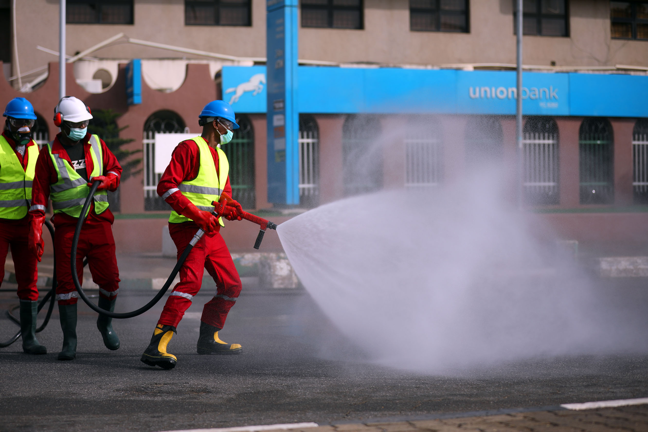 Fire service crews decontaminate the street on the third day of a 14-day lockdown aimed at limiting the spread of coronavirus disease (COVID-19), in Abuja, Nigeria April 2, 2020. Photo: Sodiq Adelakun / Channels TV