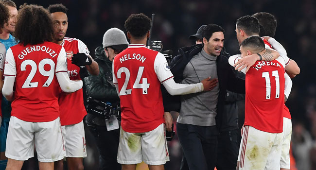 In this file photo taken on January 1, 2020 Arsenal's Spanish head coach Mikel Arteta (C) celebrates with his players on the pitch after the English Premier League football match between Arsenal and Manchester United at the Emirates Stadium in London. Ben STANSALL / AFP