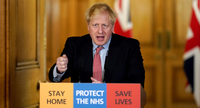 In this file photo taken on March 25, 2020 A handout image released by 10 Downing Street, shows Britain's Prime Minister Boris Johnson speaking during a remote press conference to update the nation on the Covid-19 pandemic, in side 10 Downing Street in central London on March 25, 2020. 10 Downing Street / AFP