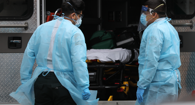 Medics wear protective gear as they arrive at a Brooklyn hospital to pick up a patient on April 18, 2020 in the Brooklyn borough of New York City. Spencer Platt/Getty Images/AFP