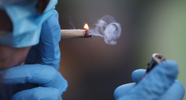 A recreational marijuana smoker indulges in smoking weed on April 14, 2020 in the Bushwick section of the Brooklyn borough of New York City. Bruce Bennett/Getty Images/AFP