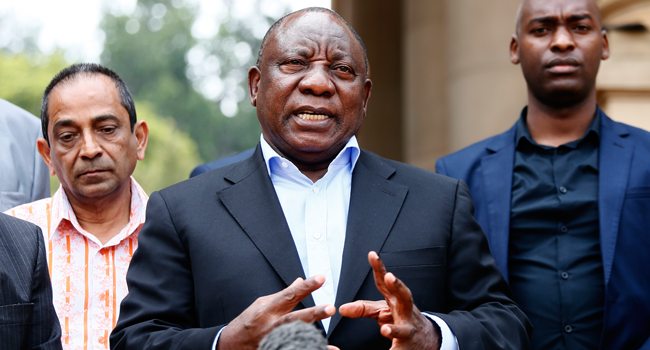 In this file photo taken on March 22, 2020 South African President Cyril Ramaphosa (C) conducts a media briefing at the end of a meeting with various business leaders and political party leaders on matters relating to the COVID-19 outbreak at the Union Buildings in Pretoria. Phill Magakoe / AFP