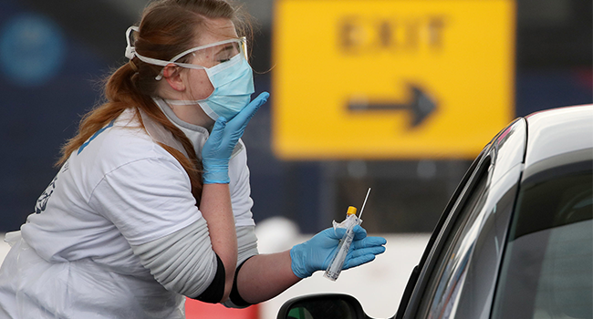 A medical worker tests a key worker for the novel coronavirus Covid-19 at a drive-in testing centre at Glasgow Airport on April 29, 2020, as the UK continues in lockdown to help curb the spread of the coronavirus. Andrew Milligan / POOL / AFP