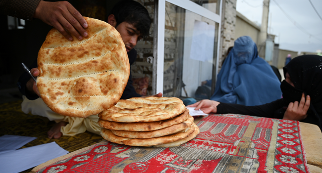 Women wait to receive free bread from the municipality outside a bakery during the Islamic holy month of Ramadan as government-imposed a nationwide lockdown as a preventive measure against the COVID-19 coronavirus, in Kabul on April 29, 2020. WAKIL KOHSAR / AFP