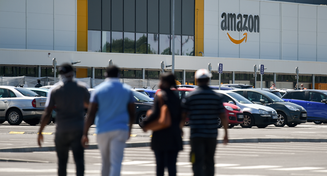 Amazon workers arrive at the company's centre in Bretigny-sur-Orge on May 19, 2020 as Amazon France partially reopens amid the pandemic of the novel coronavirus (COVID-19). Eric PIERMONT / AFP