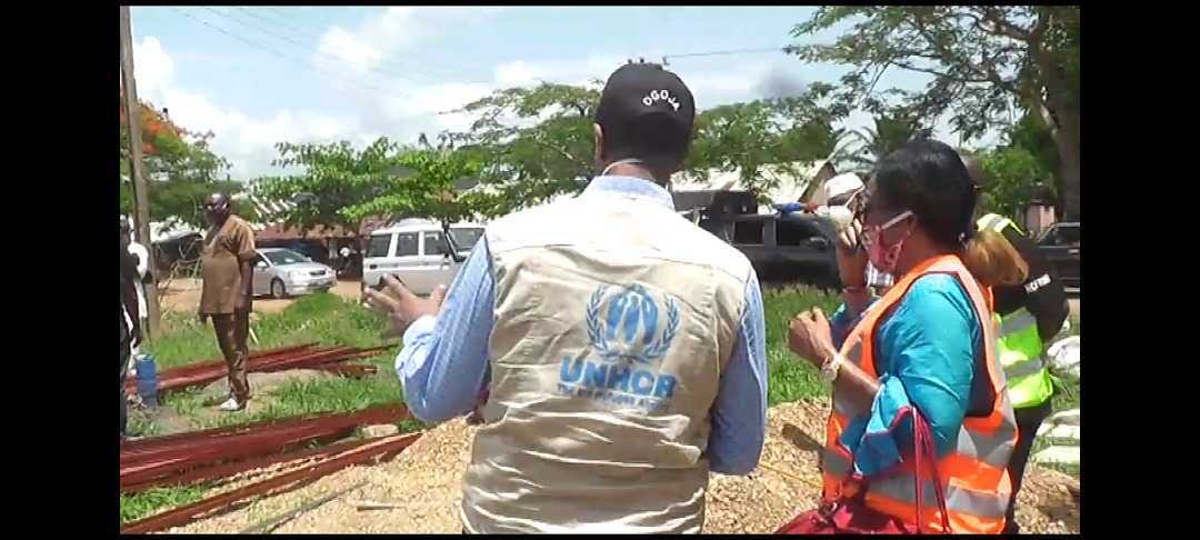 A UNHCR official inspects a scene.